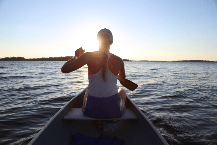 a person standing next to a body of water