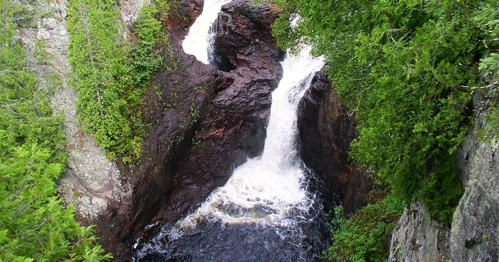 The Kettle Falls Full Day Tour Image 1 a large waterfall in a forest