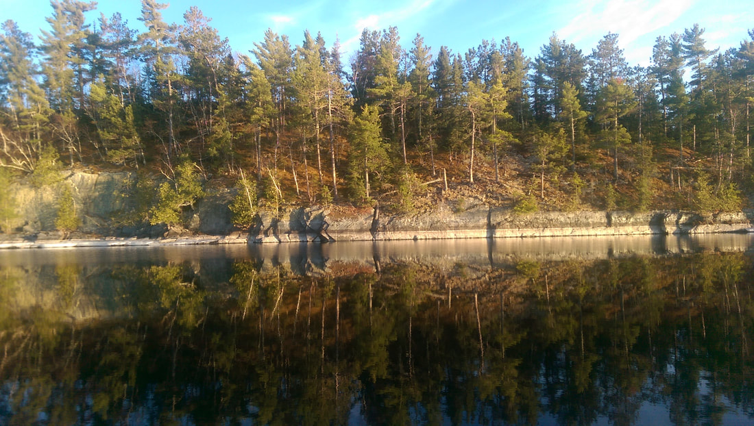 a pond next to a body of water