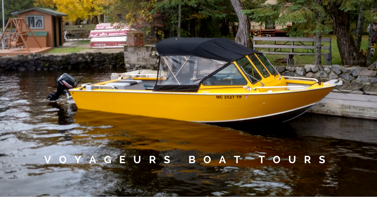 voyageurs-outfitters-4_orig a small boat in a body of water